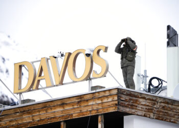 Un policía vigila desde el techo de un hotel en Davos, Suiza, el lunes 16 de enero de 2023. (AP Foto/Markus Schreiber)